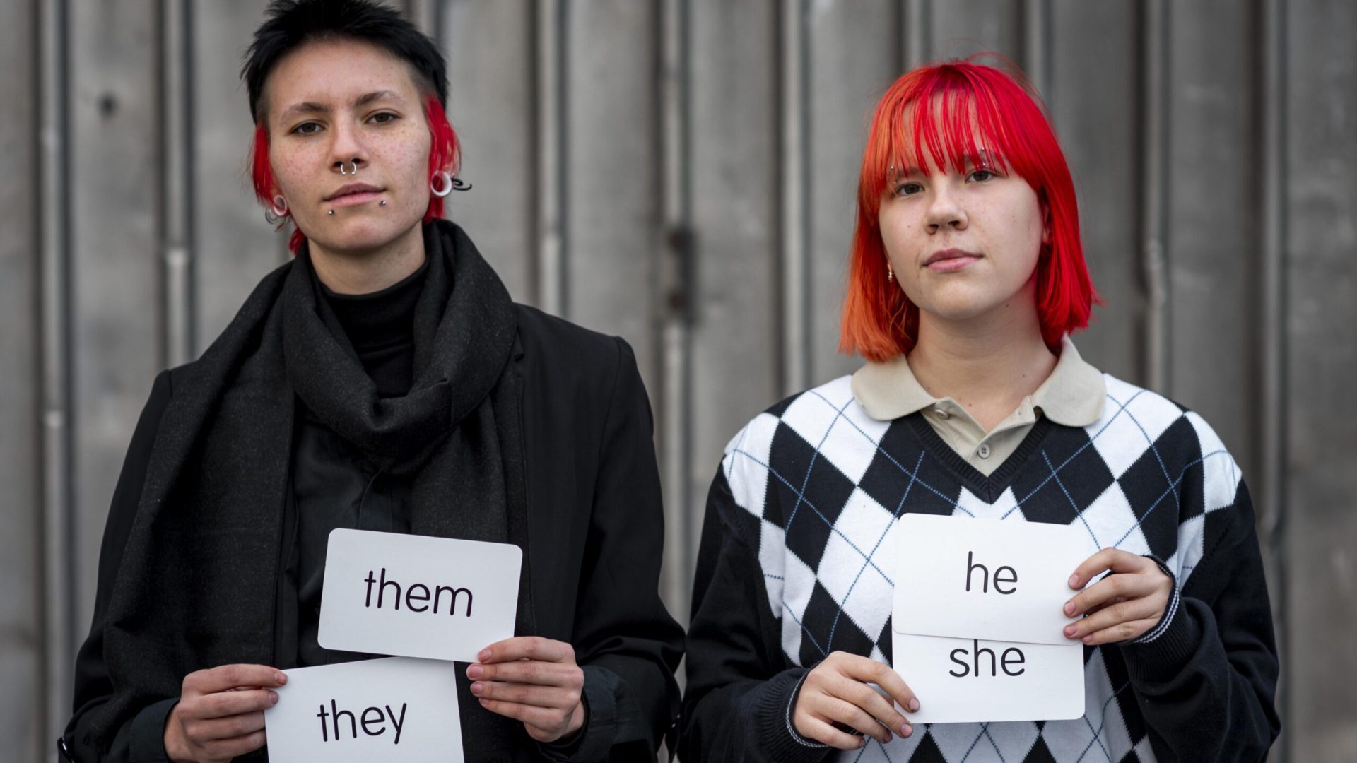 non-binary-people-holding-pronouns-cards
